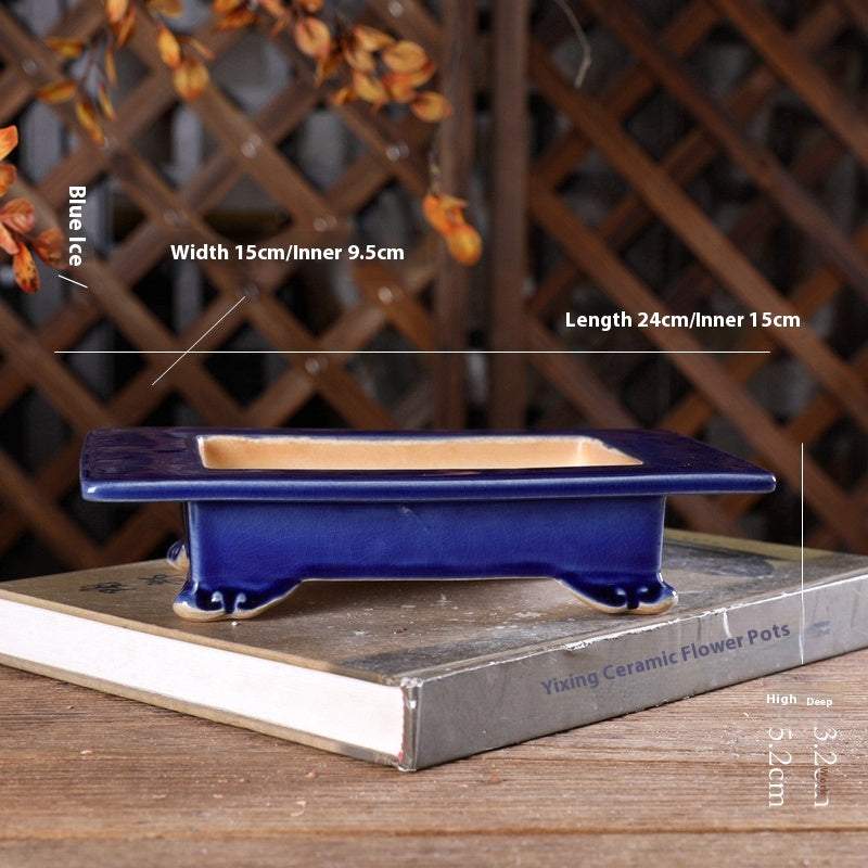 Japanese style blue ceramic basin with cloud foot design on wooden table