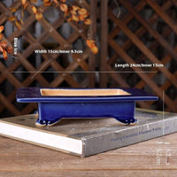 Japanese style blue ceramic basin with cloud foot design on wooden table