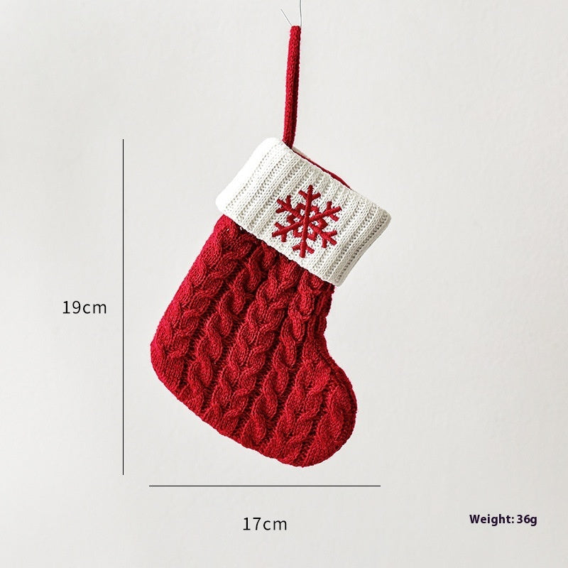 Festive knitted stockings Christmas Decoration hanging by fireplace