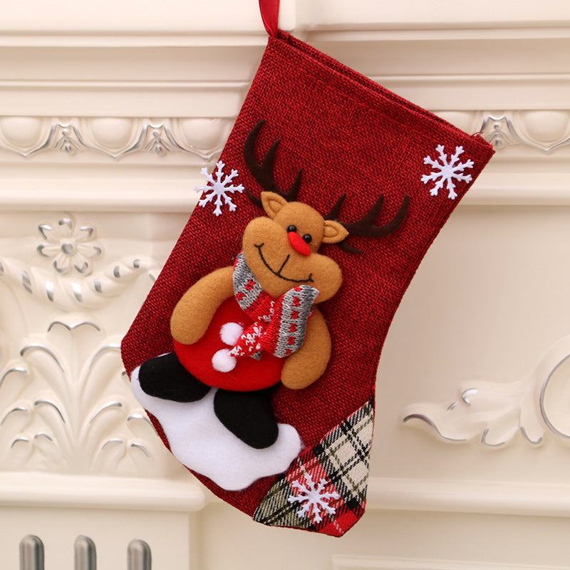 Red Christmas stocking with reindeer and snowflake decorations hanging on mantel Christmas decorations