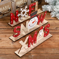 Set of Christmas wooden ornaments with festive letters and shapes including Santa, snowman, and snowflake designs.