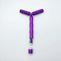 Purple 3D roller face massager with two textured rollers and detachable end cap.