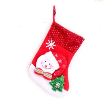 Red Christmas stocking with Santa Claus and Christmas tree decoration hanging
