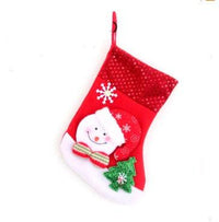 Red Christmas stocking with Santa Claus and Christmas tree decoration hanging