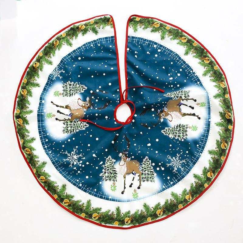 Christmas tree skirt with reindeer and snowflake design on blue background and green pine border