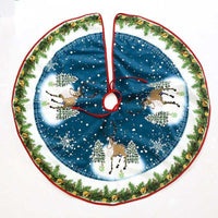Christmas tree skirt with reindeer and snowflake design on blue background and green pine border