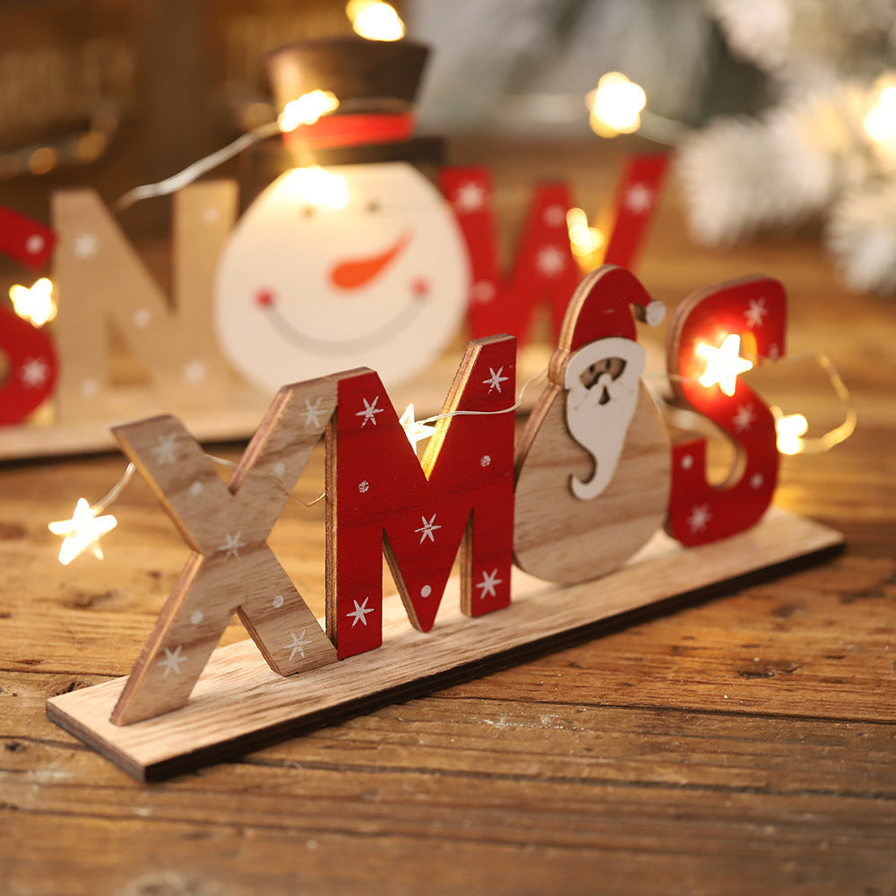 Set of Christmas wooden ornaments with festive letters and shapes including Santa, snowman, and snowflake designs.