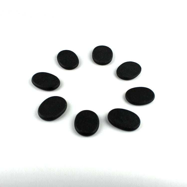 Black volcanic energy stones arranged in a circle for energy stone massage therapy