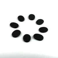 Black volcanic energy stones arranged in a circle for energy stone massage therapy