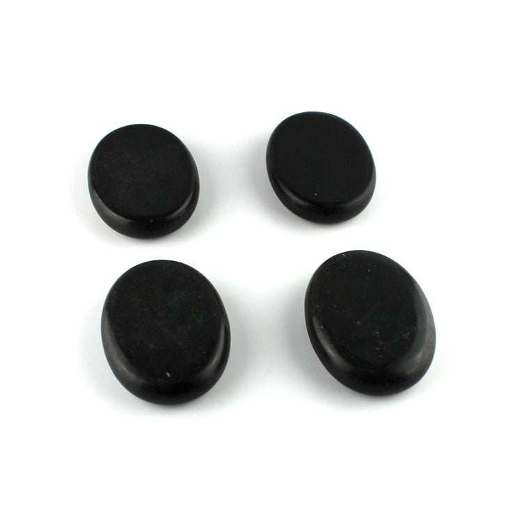 Four smooth black energy stones for massage and health therapy