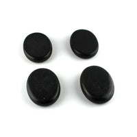Four smooth black energy stones for massage and health therapy