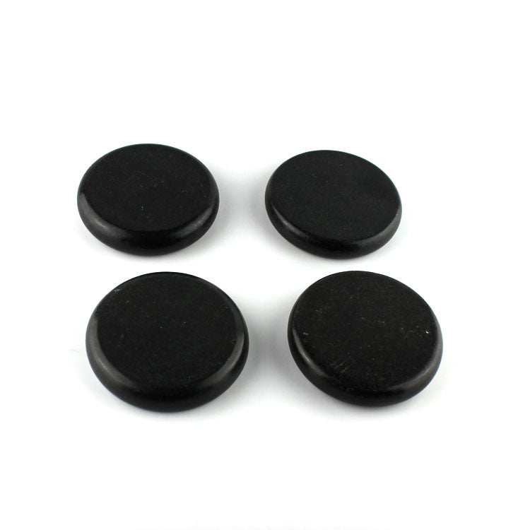 Set of four black energy stones for massage and health therapy