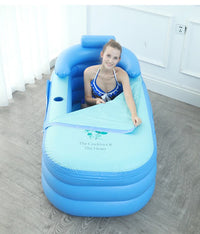 woman relaxing in blue folding inflatable bathtub with backrest and cover indoors