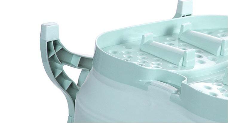 Green foldable footbath with massage balls and space-saving design for foot washing and bathing