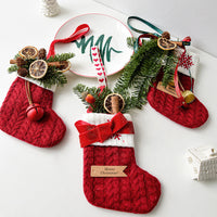 Festive knitted stockings Christmas Decoration hanging by fireplace