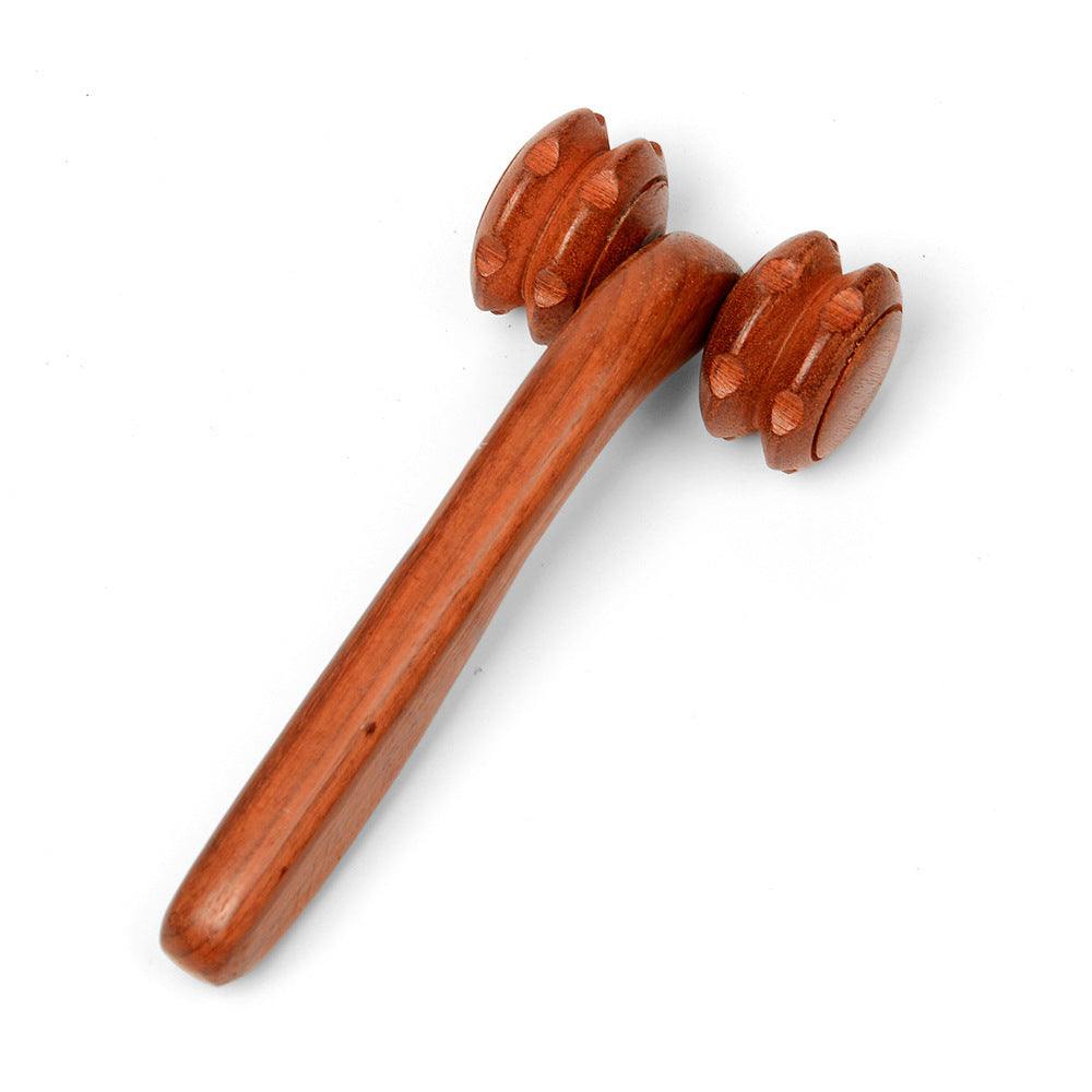 Hand holding rosewood two-wheel massager with rolling wheels for massage