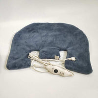Woman using electric heating shoulder guard neck wrap for pain relief at home