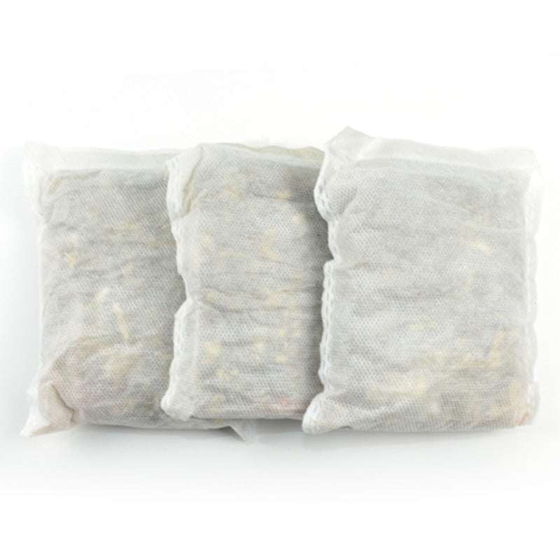 Three white mesh foot bath foot bags filled with herbal ingredients for soaking feet