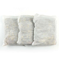 Three white mesh foot bath foot bags filled with herbal ingredients for soaking feet