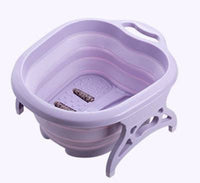 Foldable footbath massage bucket in purple plastic with built-in massage rollers and collapsible design for easy storage