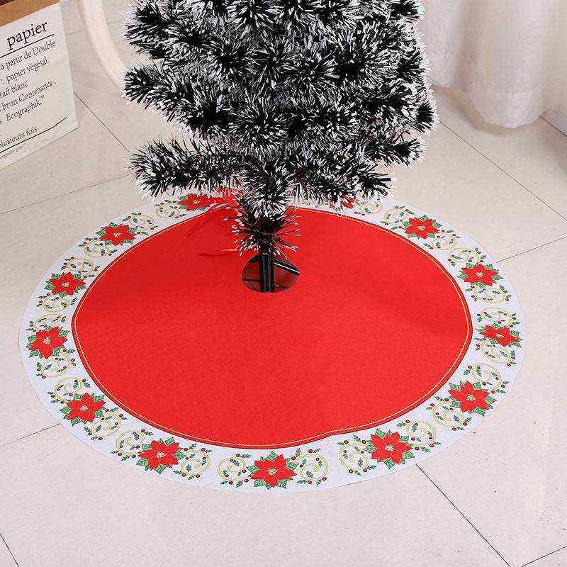 Red Christmas tree skirt with poinsettia border under artificial tree, soft fabric material, available in multiple sizes