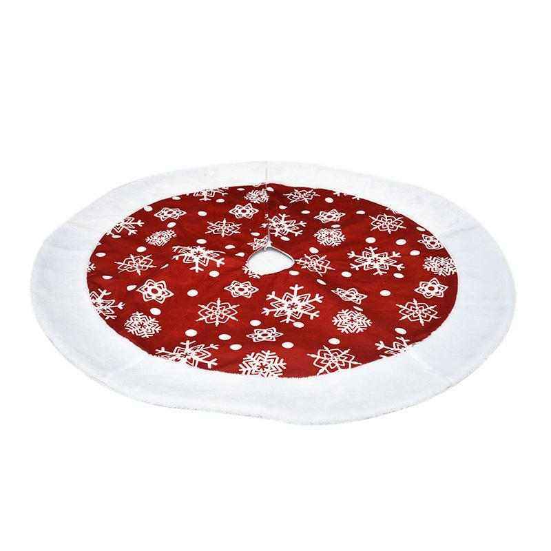 Red Christmas tree skirt with white snowflake patterns and white border made of soft fabric
