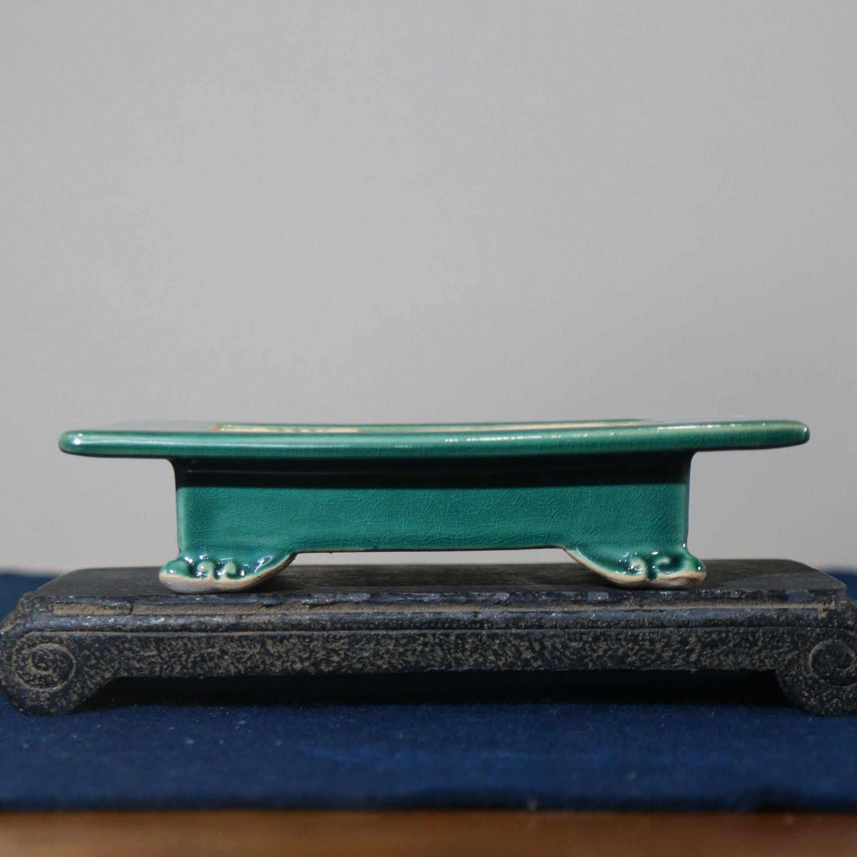 Japanese style green ceramic basin with cloud foot design on wooden stand