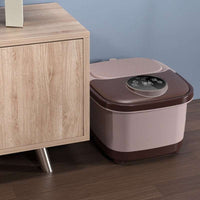 Electric heating automatic foot bath massager with digital display and remote control placed next to wooden cabinet