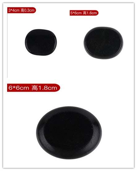 Black natural volcanic spa energy stones in various sizes for massage therapy