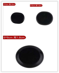 Black natural volcanic spa energy stones in various sizes for massage therapy