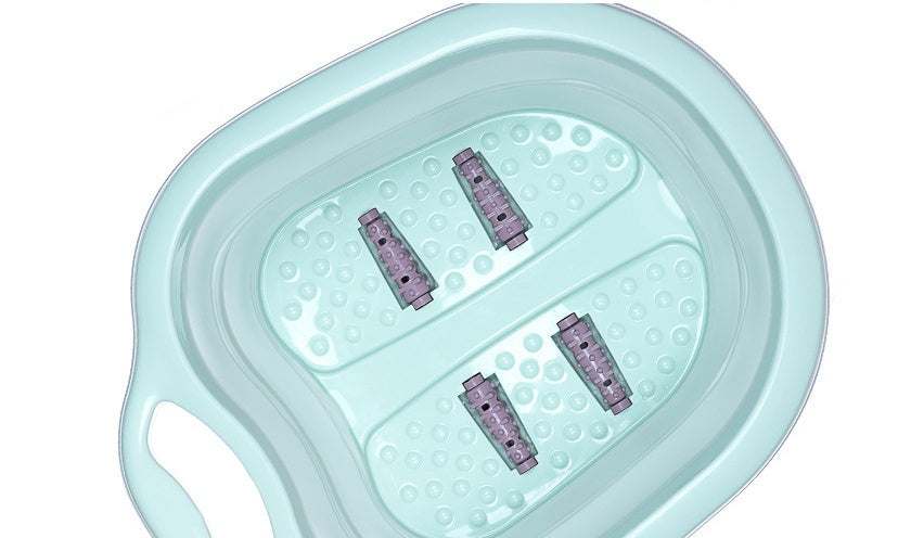 Green foldable footbath with massage rollers and ergonomic handle for easy storage and foot care.