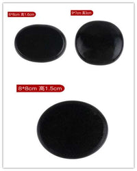Natural black spa energy stones in various sizes for hot stone massage therapy