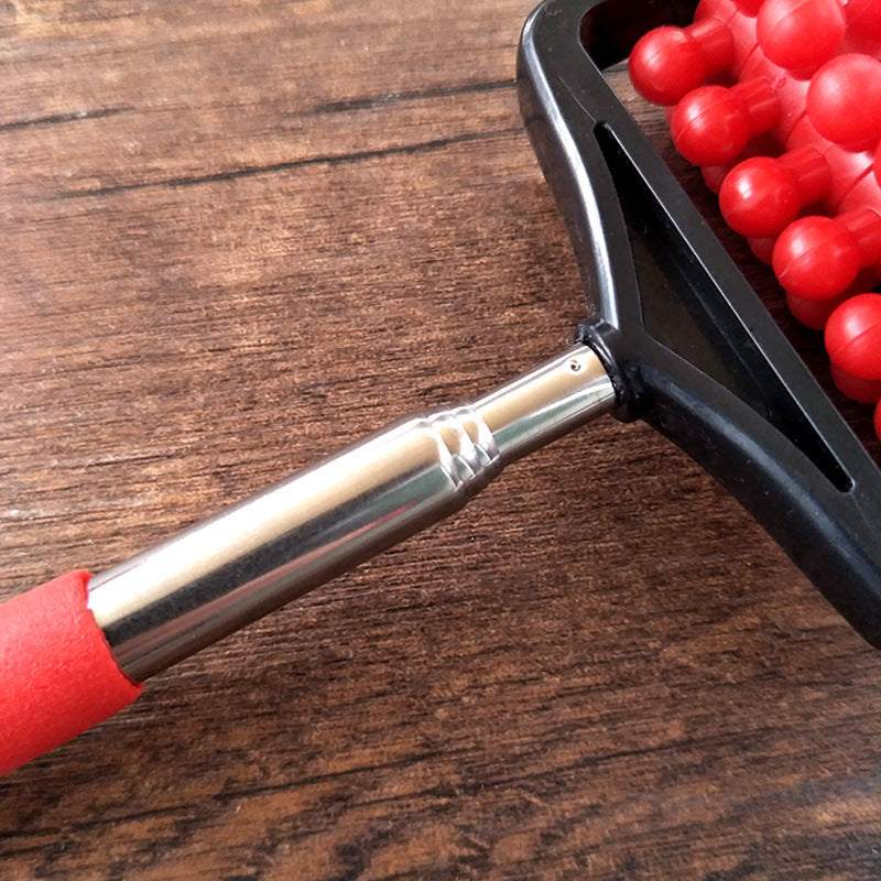 Telescopic plastic massage roller with red handle and stainless steel extension on wooden surface