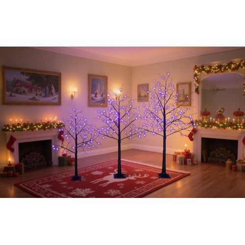 Three lighted black Halloween spooky trees with purple LED lights in various heights in a decorated living room
