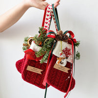 Festive knitted stockings Christmas Decoration hanging by fireplace