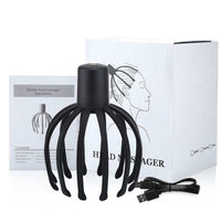 Black electric scalp massager with flexible TPE arms, USB charging cable, instruction manual, and white packaging box.