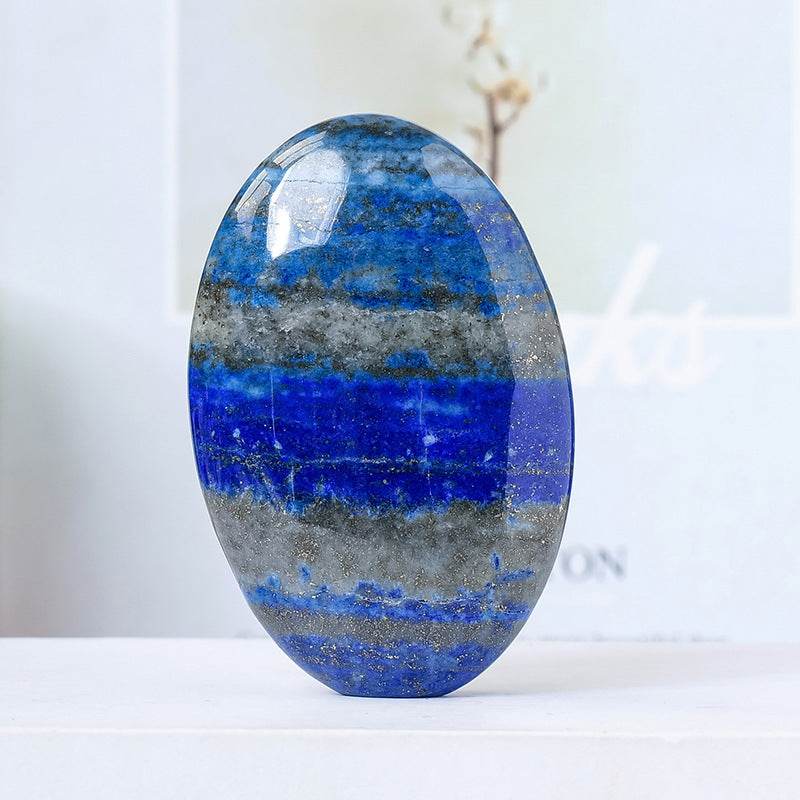Natural crystal hot compress oval stone in blue and gray tones with polished surface