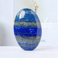 Natural crystal hot compress oval stone in blue and gray tones with polished surface
