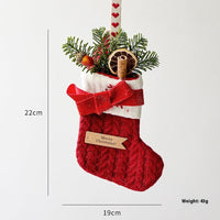 Festive knitted stockings Christmas Decoration hanging by fireplace