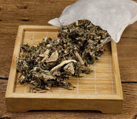 Foot bath foot bag with dried herbal leaves on wooden tray for foot soaking therapy