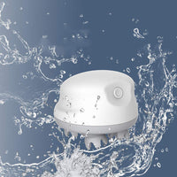 Waterproof white head massager with kneading silicone scalp brushes and power button on blue background with water splashes