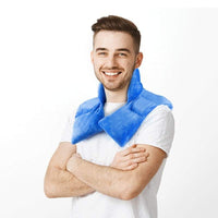 Man using blue flaxseed gravity neck shoulder pad for pain relief while working on laptop