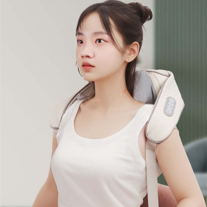 Woman using a rechargeable shoulder and neck trapezius massager in milky white color with remote control