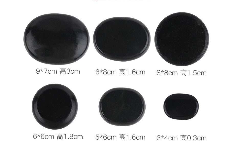 Black natural volcanic spa energy stones in various sizes for hot stone massage therapy