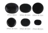 Black natural volcanic spa energy stones in various sizes for hot stone massage therapy