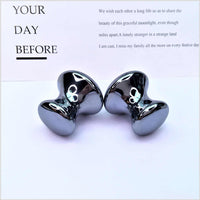 Quantum Stone Terahertz mushroom-shaped handheld massager in metallic finish for relaxing massage