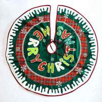 Green and red plaid Christmas tree skirt with "Merry Christmas" text and snowflake decorations