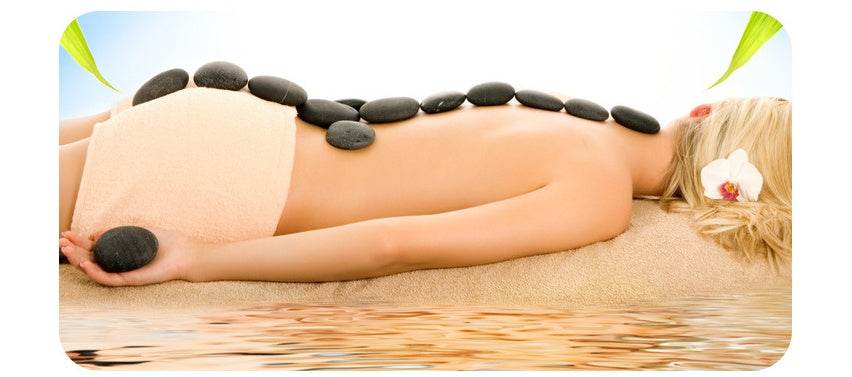 Spa energy stones placed on back for hot stone massage therapy