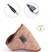 Woman wearing electric heating neck massage belt with USB power plug on beige background