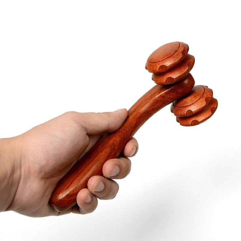 Hand holding rosewood two-wheel massager with rolling wheels for massage